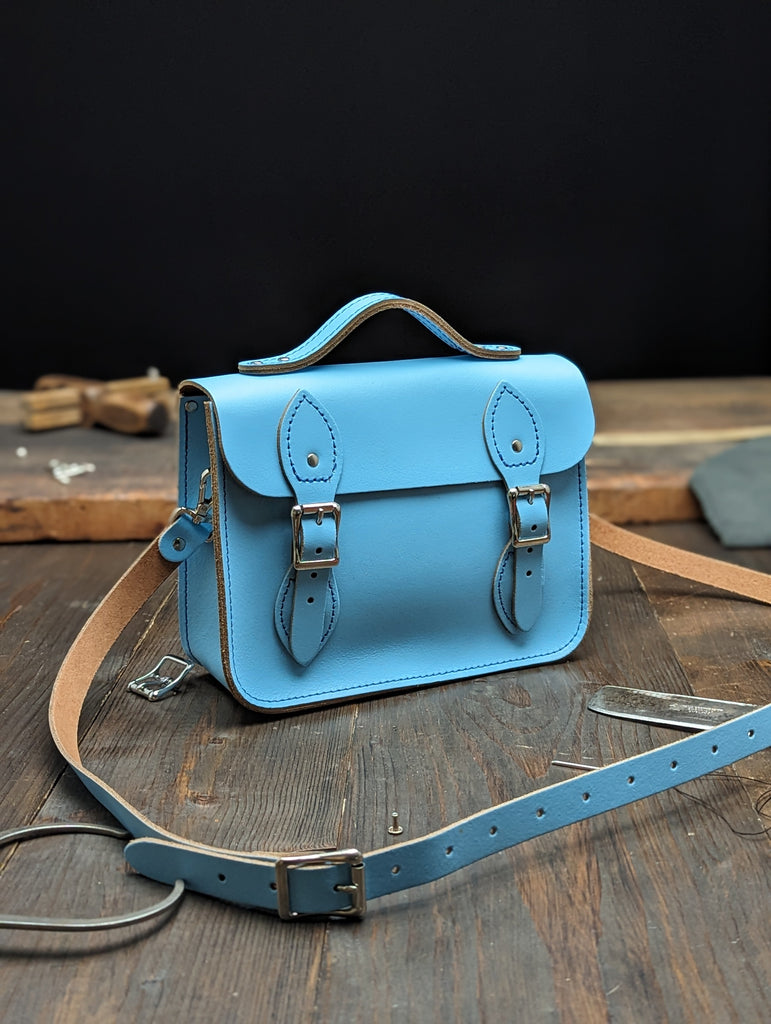 Festival Satchel with a 20mm Volume Boost, a Bolt-on Handle, No Address Card Window and an Outer Slip Pocket made from Baby Blue Leather (MMRP £121)