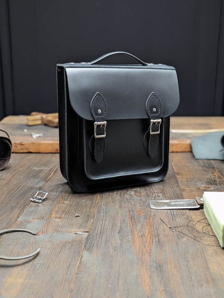 Small Portrait Backpack with a 25mm Volume Boost made from Charcoal Black Leather (MMRP £171)